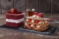 Mille feuille dessert sweet slice red velvet cake with white frosting is garnished with strawberries Royalty Free Stock Photo
