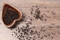 milled black pepper ,Black pepper corns on an old wooden background Royalty Free Stock Photo