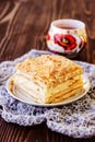 Millefeuille pastry with a cup of tea on wooden table Royalty Free Stock Photo