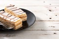 Millefoglie or French mille-feuille on white wooden table.