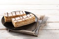 Millefoglie or French mille-feuille on white wooden table.