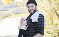 Millenial Dad with Baby in Carrier Outside Walking Royalty Free Stock Photo