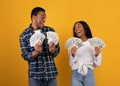 Millennial african american male and female hold many dollars in hands and expressing success Royalty Free Stock Photo