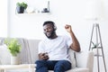 Millennial african american man in headphones enjoying music