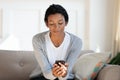 Millennial African American woman use smartphone at home Royalty Free Stock Photo