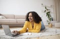 Millennial African American woman using laptop pc, working or studying online, having business meeting or remote lesson Royalty Free Stock Photo