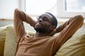Millennial african man resting on couch at home Royalty Free Stock Photo