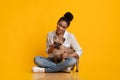 Millennial Afro Dog Sitting On Floor With Her French Bullgod Puppy Royalty Free Stock Photo