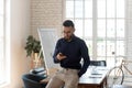 Arabian businessman busy using modern smartphone in office Royalty Free Stock Photo