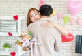 Millennial Asian beautiful female girlfriend standing smiling holding roses flower bouquet hugging cuddling showing love with Royalty Free Stock Photo