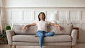 Millennial asian girl relax on modern sofa at home Royalty Free Stock Photo