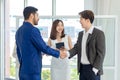 Millennial Asian Indian multinational professional successful businessmen in formal suit standing shaking hands greeting say Royalty Free Stock Photo