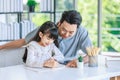 Millennial Asian lovely happy family father helping teaching young little girl daughter using touchscreen tablet computer and Royalty Free Stock Photo