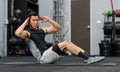 Millennial Asian strong young fit male muscular fitness model in sportswear sleeveless shirt and sporty shorts laying down sit up Royalty Free Stock Photo
