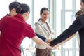 Millennial Asian young beautiful professional successful businesswoman in formal suit standing holding hands with male and female Royalty Free Stock Photo