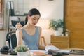 The millennial Asian young businesswoman is making notes for a business plan on her notebook, focusing on business Royalty Free Stock Photo