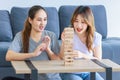 Millennial Asian young happy cheerful joyful female lesbian LGBTQ lover couple sitting smiling laughing together on carpet floor Royalty Free Stock Photo