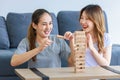 Millennial Asian young happy cheerful joyful female lesbian LGBTQ lover couple sitting smiling laughing together on carpet floor Royalty Free Stock Photo