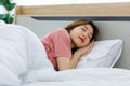 Millennial Asian young happy cheerful lazy sleepy female teenager laying lying down closed eyes smiling sleeping sweet dream under
