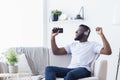 Millennial black guy singing into smartphone like microphone Royalty Free Stock Photo