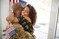 Millennial African American  soldier embracing his wife after arriving back home,close up Royalty Free Stock Photo