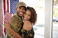 Millennial African American  soldier and his wife embracing at home and smiling to camera,close up Royalty Free Stock Photo