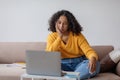 Millennial black woman feeling bored near laptop during online business meeting at home office, copy space Royalty Free Stock Photo