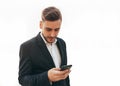 Millennial businessman looks into the screen of his mobile phone. Close-up portrait. Young successful, stylish business man Royalty Free Stock Photo