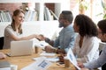 Millennial businesswoman handshake black employee greeting at me Royalty Free Stock Photo