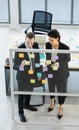 Millennial Caucasian businessman and businesswoman colleague in formal suit standing discussing consulting talking use memory