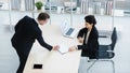 Millennial Caucasian successful thoughtful businessman and businesswoman colleague teamwork in formal suit sitting standing Royalty Free Stock Photo