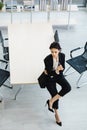 Millennial Caucasian successful young curious thoughtful businesswoman in formal suit holding pencil sitting on table thinking Royalty Free Stock Photo