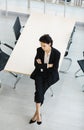 Millennial Caucasian successful young curious thoughtful businesswoman in formal suit holding pencil sitting on table thinking Royalty Free Stock Photo