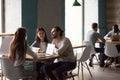 Millennial couple buying house meeting with realtor in cafe Royalty Free Stock Photo