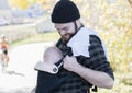 Millennial Dad with Baby in Carrier Outside Walking Royalty Free Stock Photo