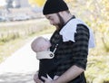 Millennial Dad with Baby in Carrier Outside Walking Royalty Free Stock Photo