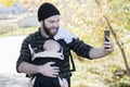 Millennial Dad with Baby in Carrier Outside Walking & Taking Sel Royalty Free Stock Photo