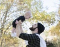 Millennial Dad Holding Baby Daughter Up Showing Affection Royalty Free Stock Photo