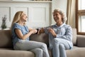 Millennial daughter drinking tea with older mom during pleasant conversation Royalty Free Stock Photo