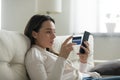 Millennial girl shopping on cell using credit card Royalty Free Stock Photo