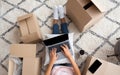 Millennial girl typing on laptop, sitting on floor