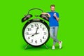 Millennial guy use telephone stand near clock isolated on chroma key background. Creative art collage app device concept