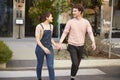 Millennial hipster couple crossing the road in the city holding hands, close up Royalty Free Stock Photo