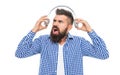 Millennial hipster man listen to music in headphones. Loud music. Man listening audio in loud music headphones. Annoyed Royalty Free Stock Photo