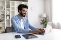 Millennial indian freelancer guy working online on laptop at home office Royalty Free Stock Photo