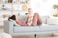 Millennial Mom Spending Time With Her Cute Toddler Son At Home, Royalty Free Stock Photo