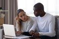 Millennial multiracial married couple calculating monthly family budget. Royalty Free Stock Photo