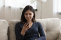 Millennial Vietnamese girl using cellphone relaxing at home Royalty Free Stock Photo