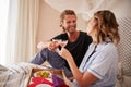 Millennial white couple celebrating, making a toast with champagne in bed, close up Royalty Free Stock Photo