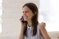 Happy woman listens great news feels excited celebrating personal success Royalty Free Stock Photo
